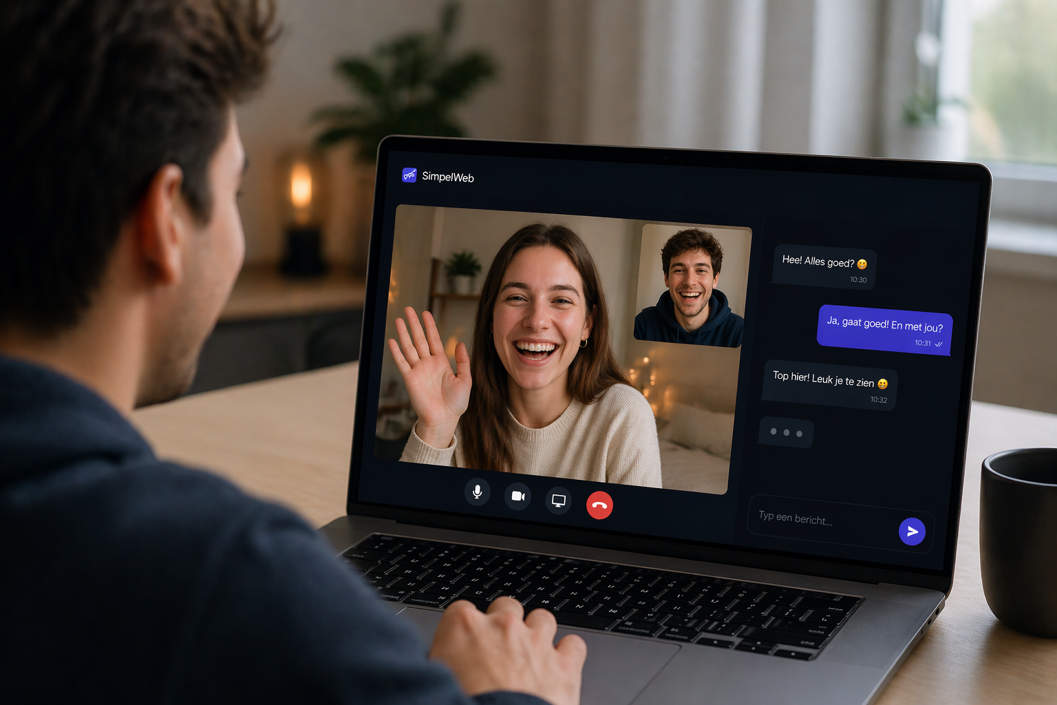 A woman waving on a video call from a laptop